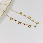 Minimal gold chain with cutout clover discs and multi colour stone bead charms
