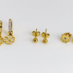 Set of gold earrings on a white background