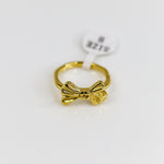 Gold bow-shaped ring  on a white background