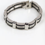 Silver and black bracelet on a white background