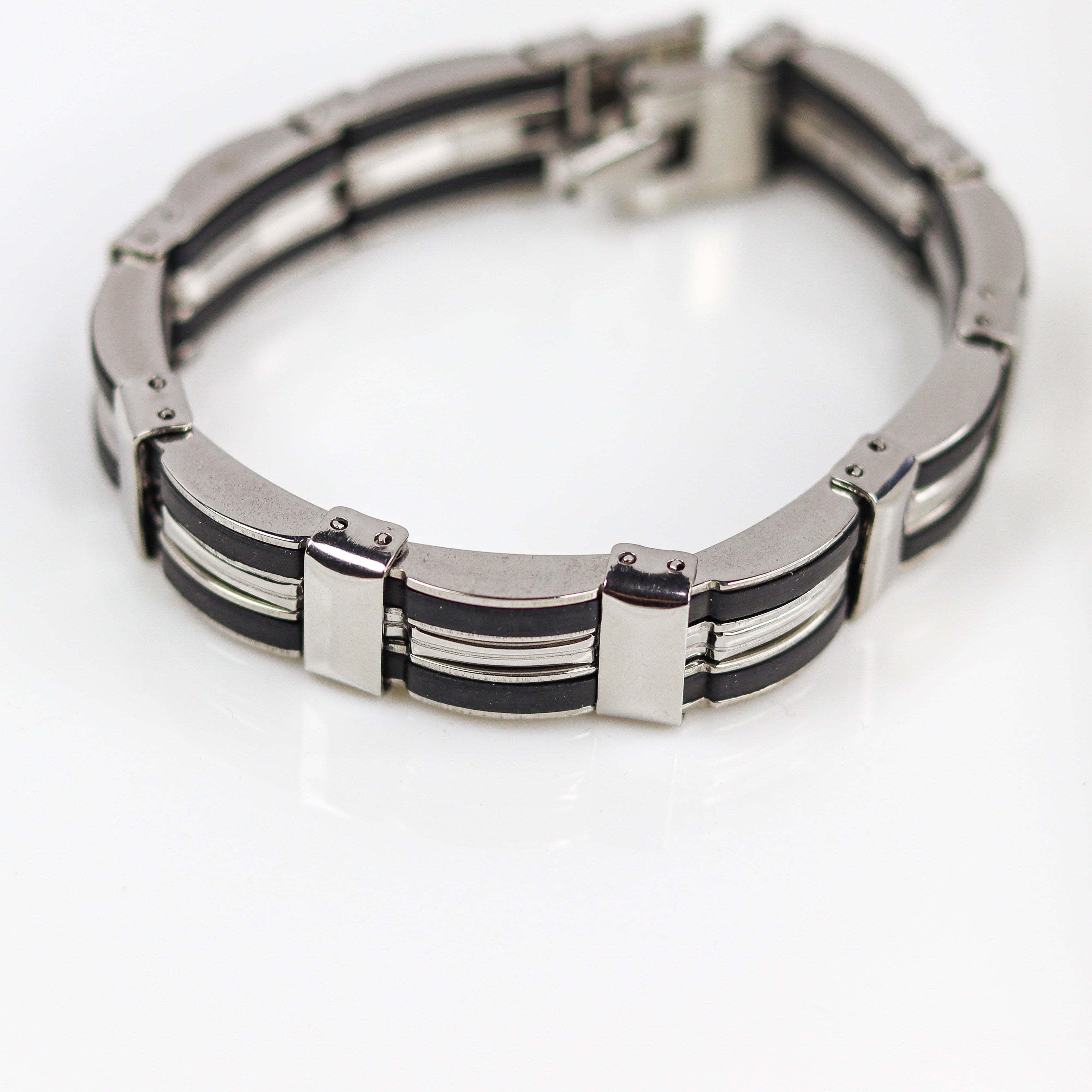 Silver and black bracelet on a white background