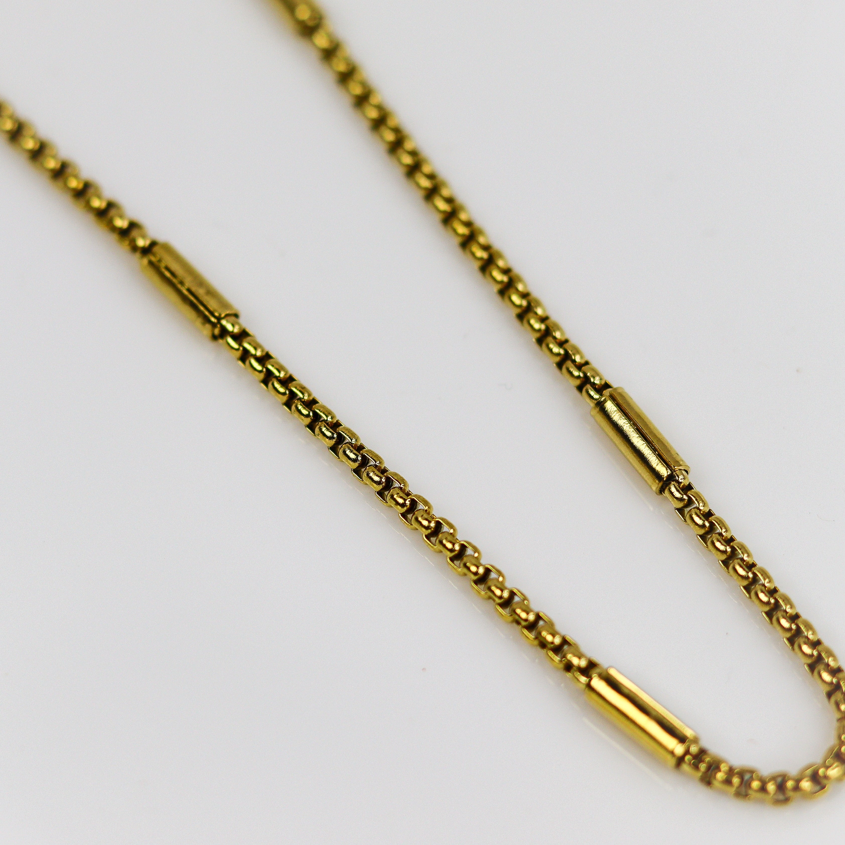 Gold chain necklace on a white background