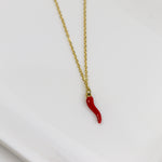 Necklace with a red chili pepper pendant on a white background