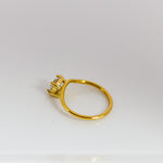 Gold ring with a diamond on a white background