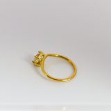 Gold ring with a diamond on a white background
