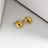 Gold bell-shaped earrings on a white background