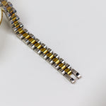 Two-tone watch strap on a white background