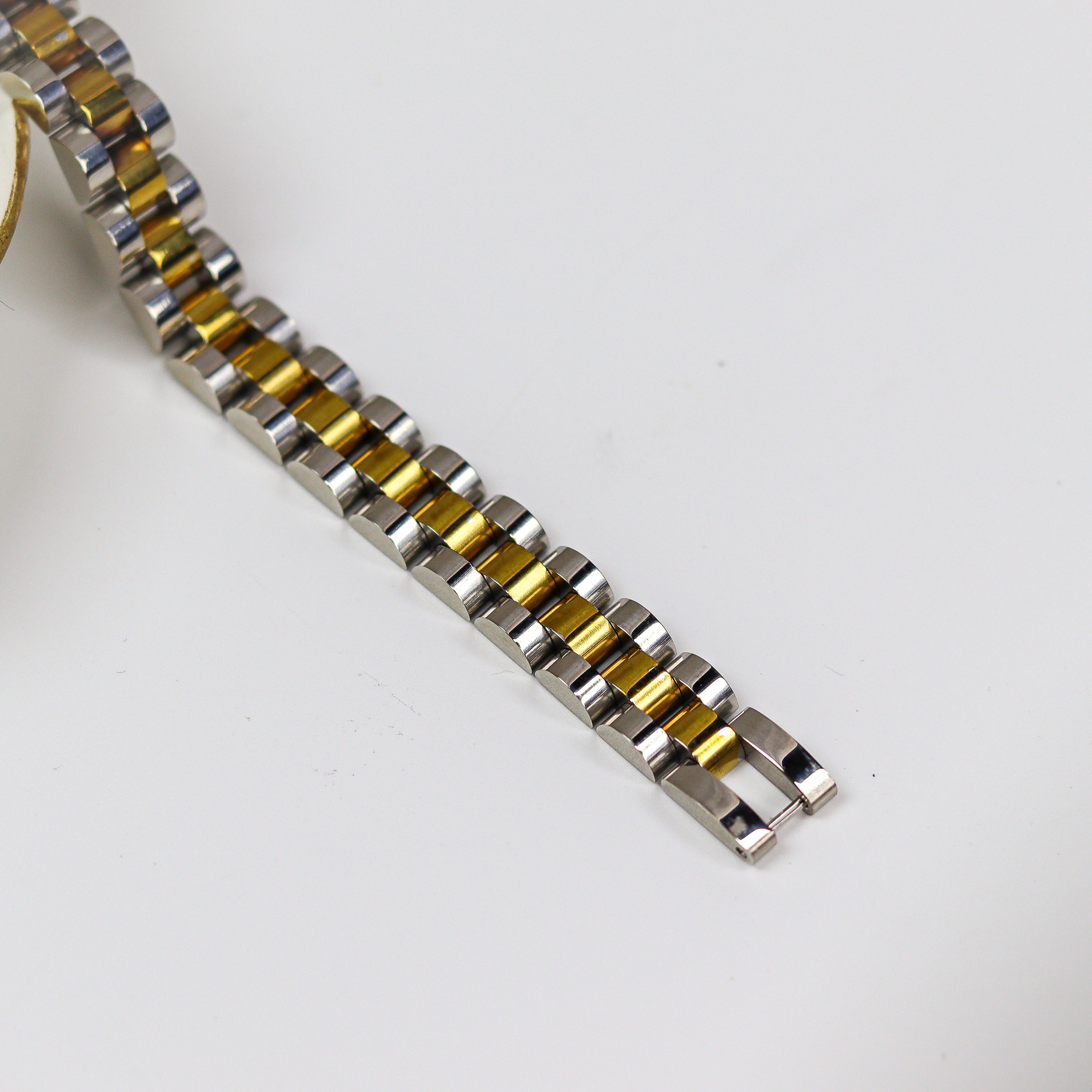 Two-tone watch strap on a white background