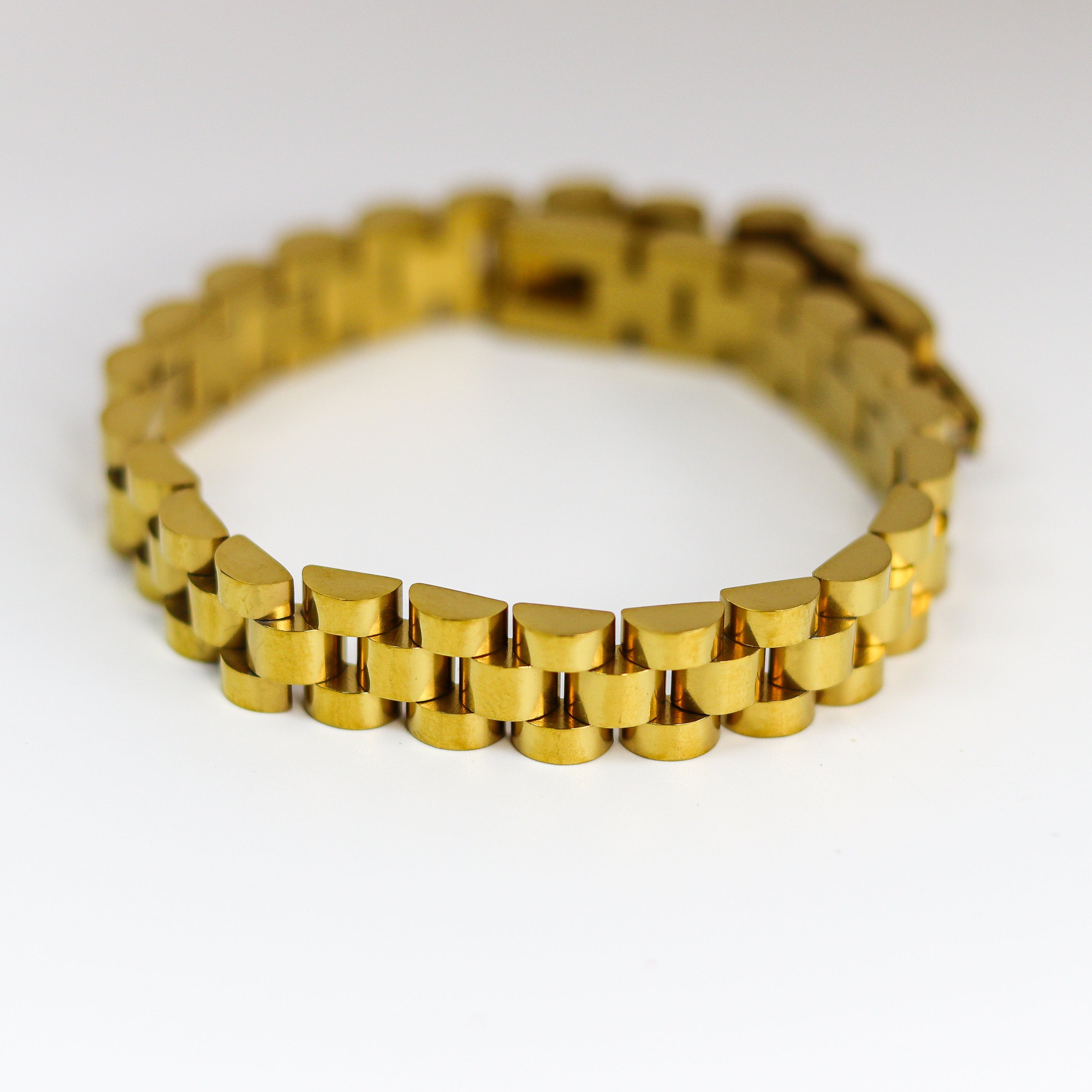 Gold bracelet on a white background
