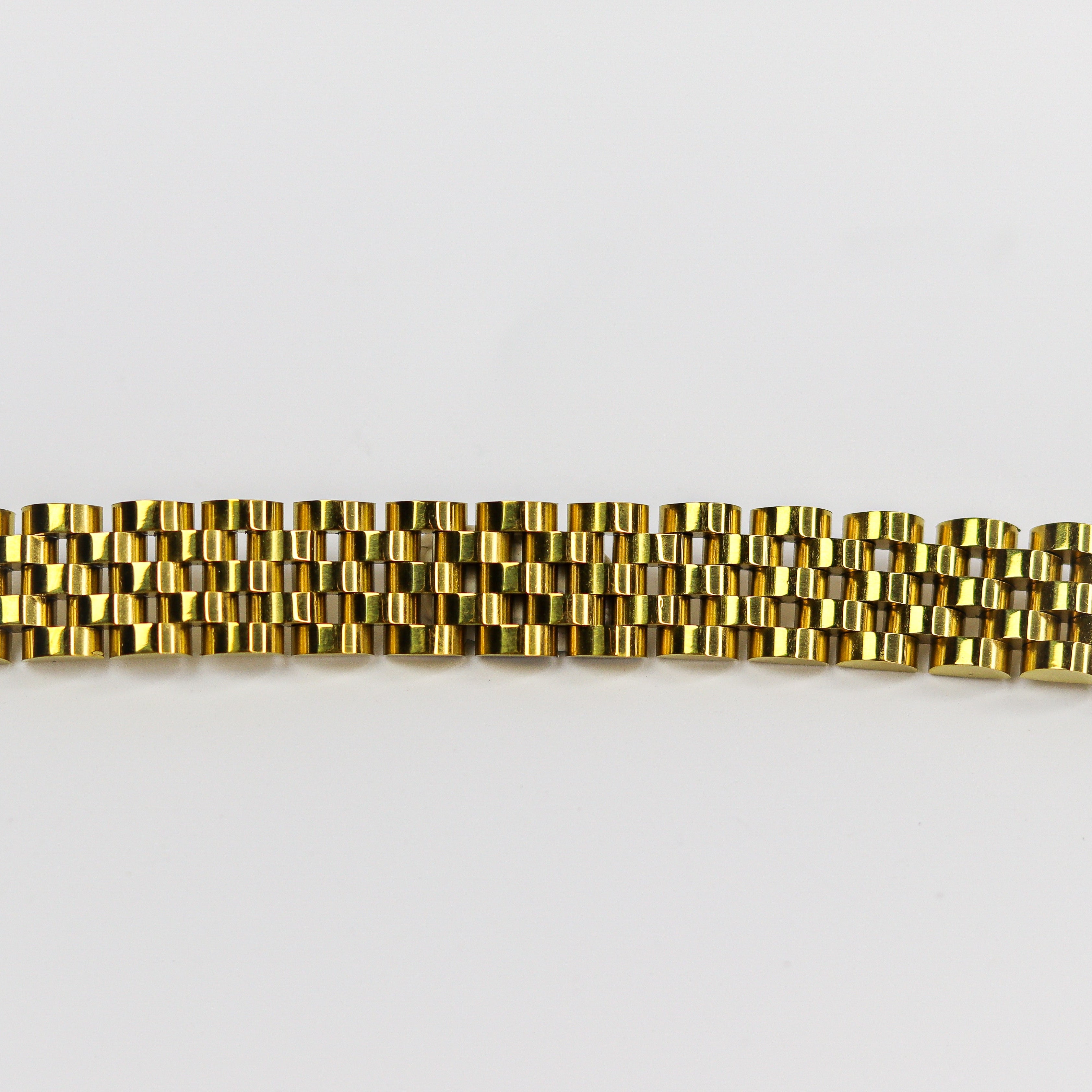 Gold bracelet on a white background