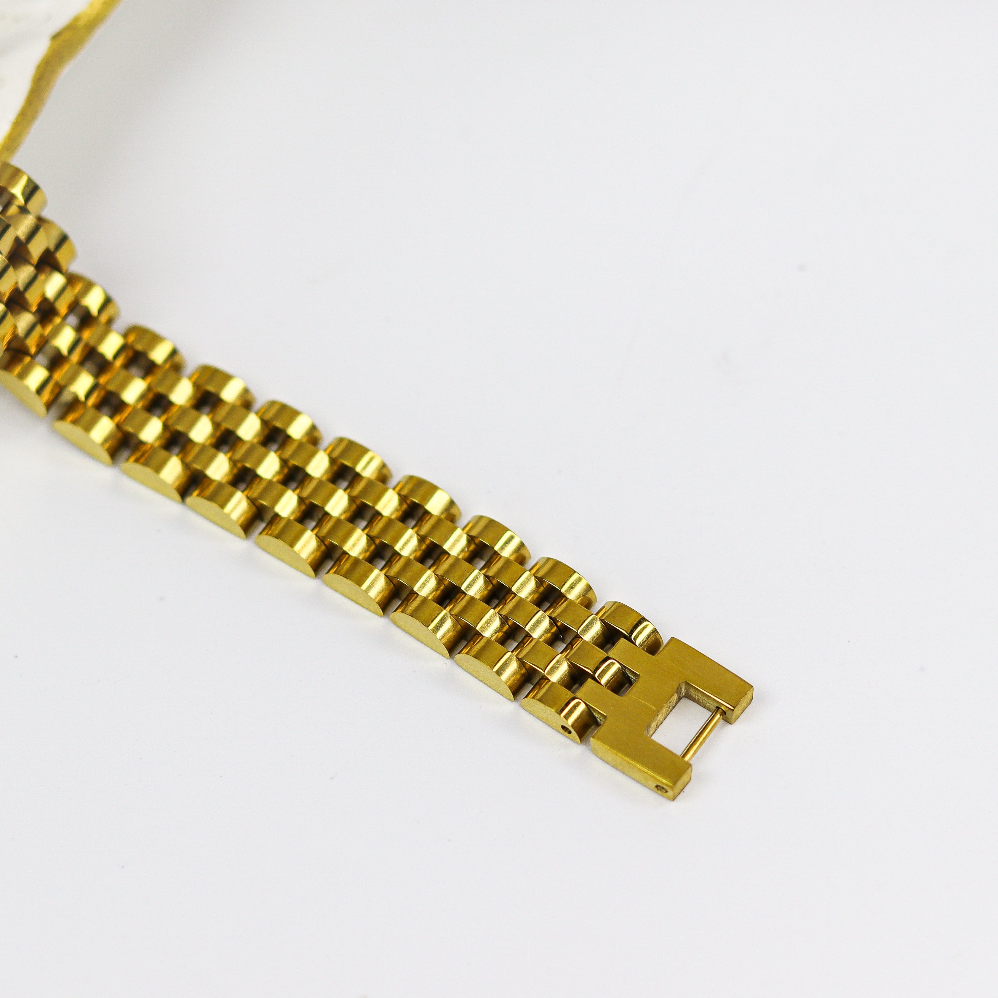 Gold watch strap on a white background
