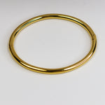 Gold bangle on a white background