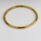 Gold bangle on a white background