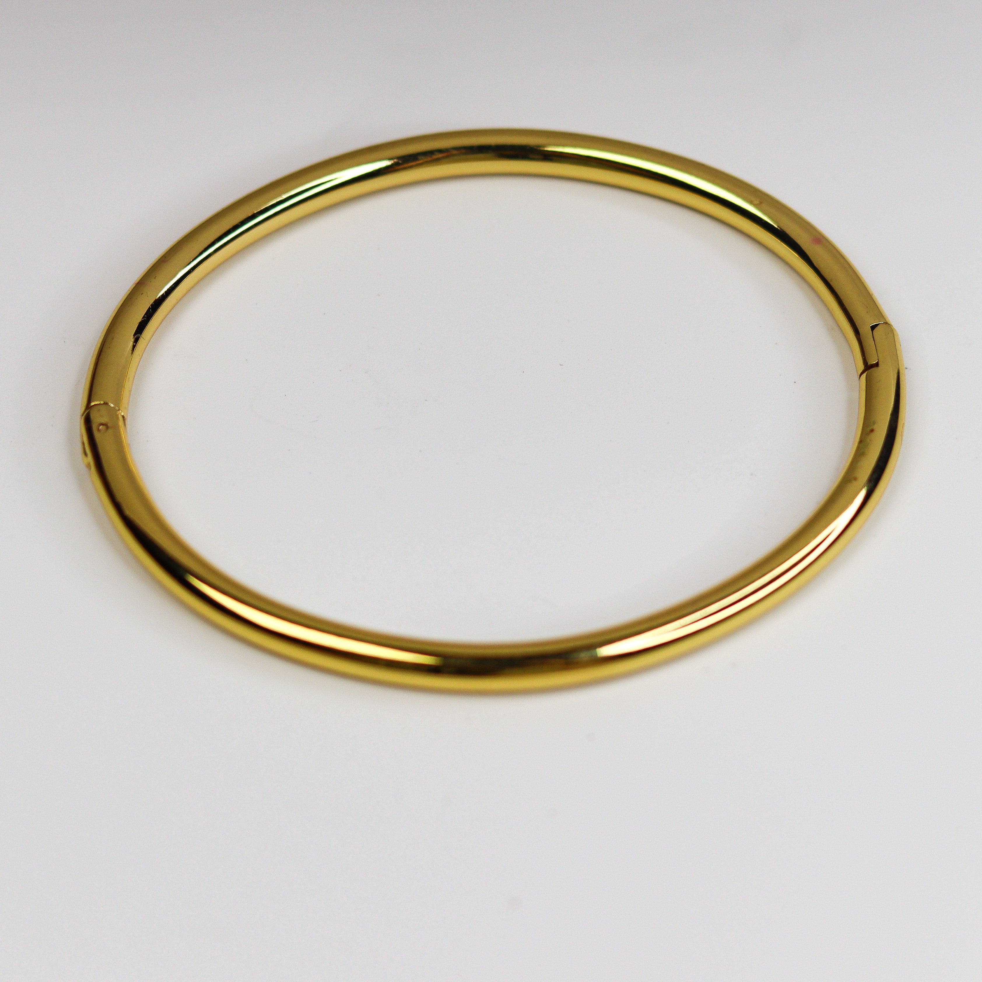 Gold bangle on a white background