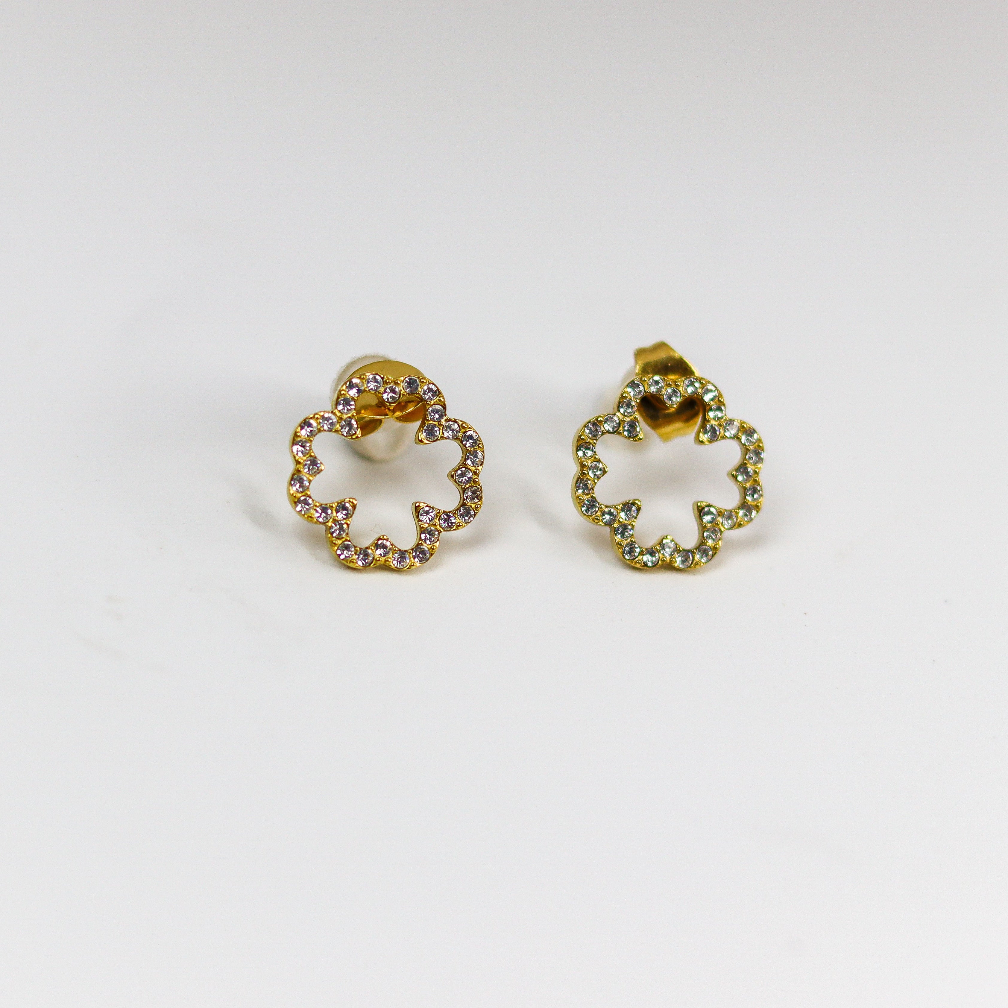 Pair of gold earrings on a white background