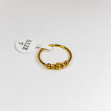 Gold ring with a small round design on a white background