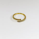 Gold ring with small stones on a white background