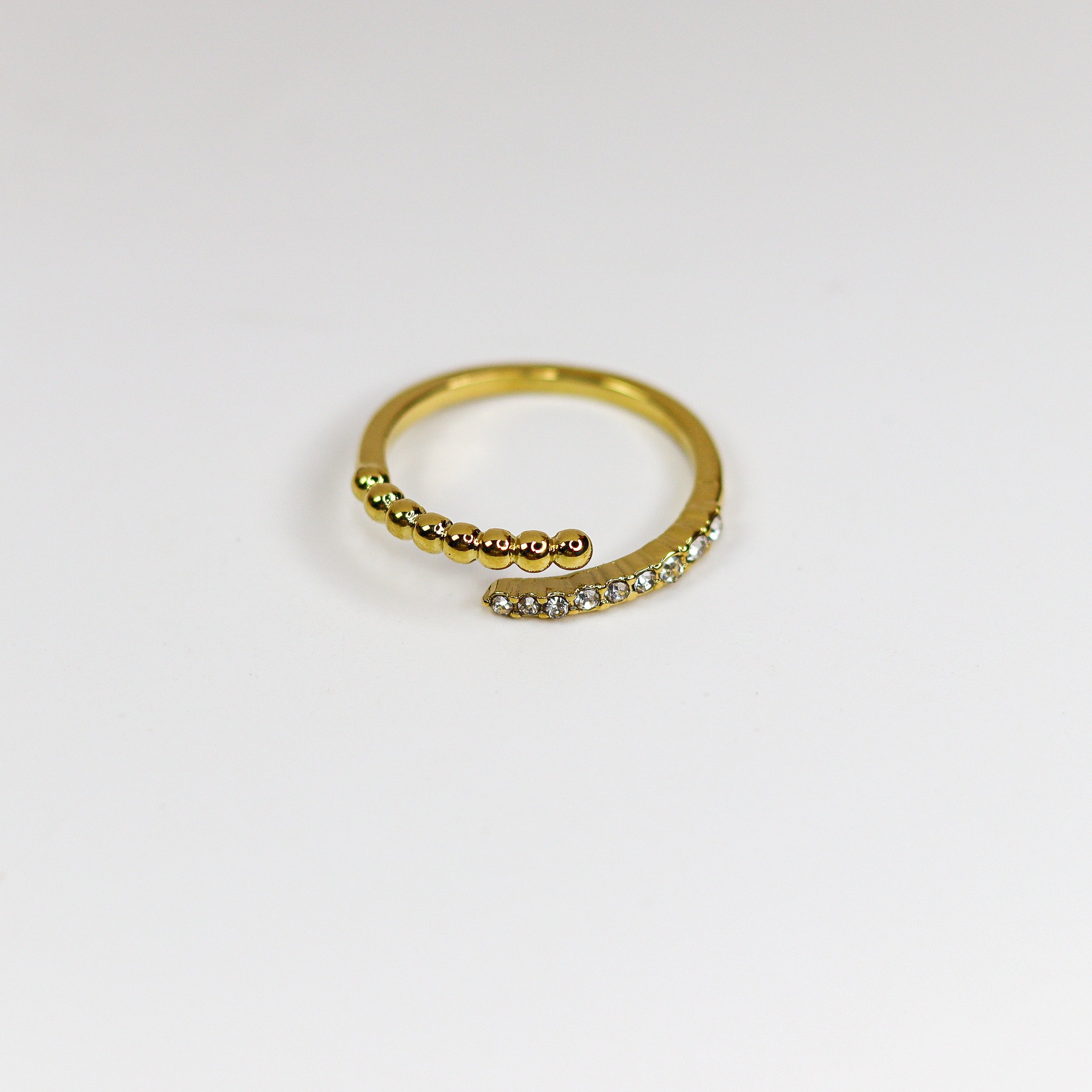 Gold ring with small stones on a white background