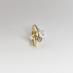 Gold ring with a heart-shaped diamond on a white background