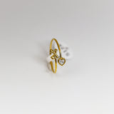 Gold ring with a heart-shaped diamond on a white background